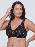 Soutien-gorge Pois MUE noir à pois blancs, porté de face, décolleté en V